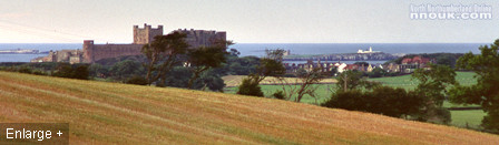 Bamburgh castle and village with the sea and Farne Islands in the background