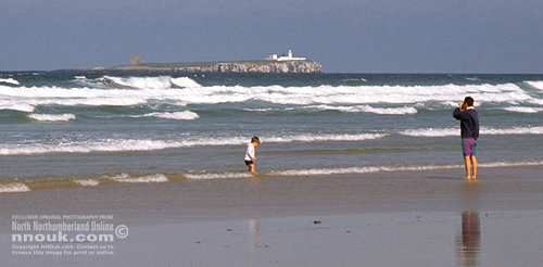 Playing in the sea on the beach at Bamburgh