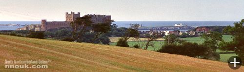 Bamburgh castle and village with the sea and Farne Islands in the background