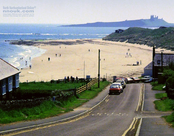 The road down to Low Newton and Embleton Bay. With Dunstanburgh Castle in the distance.